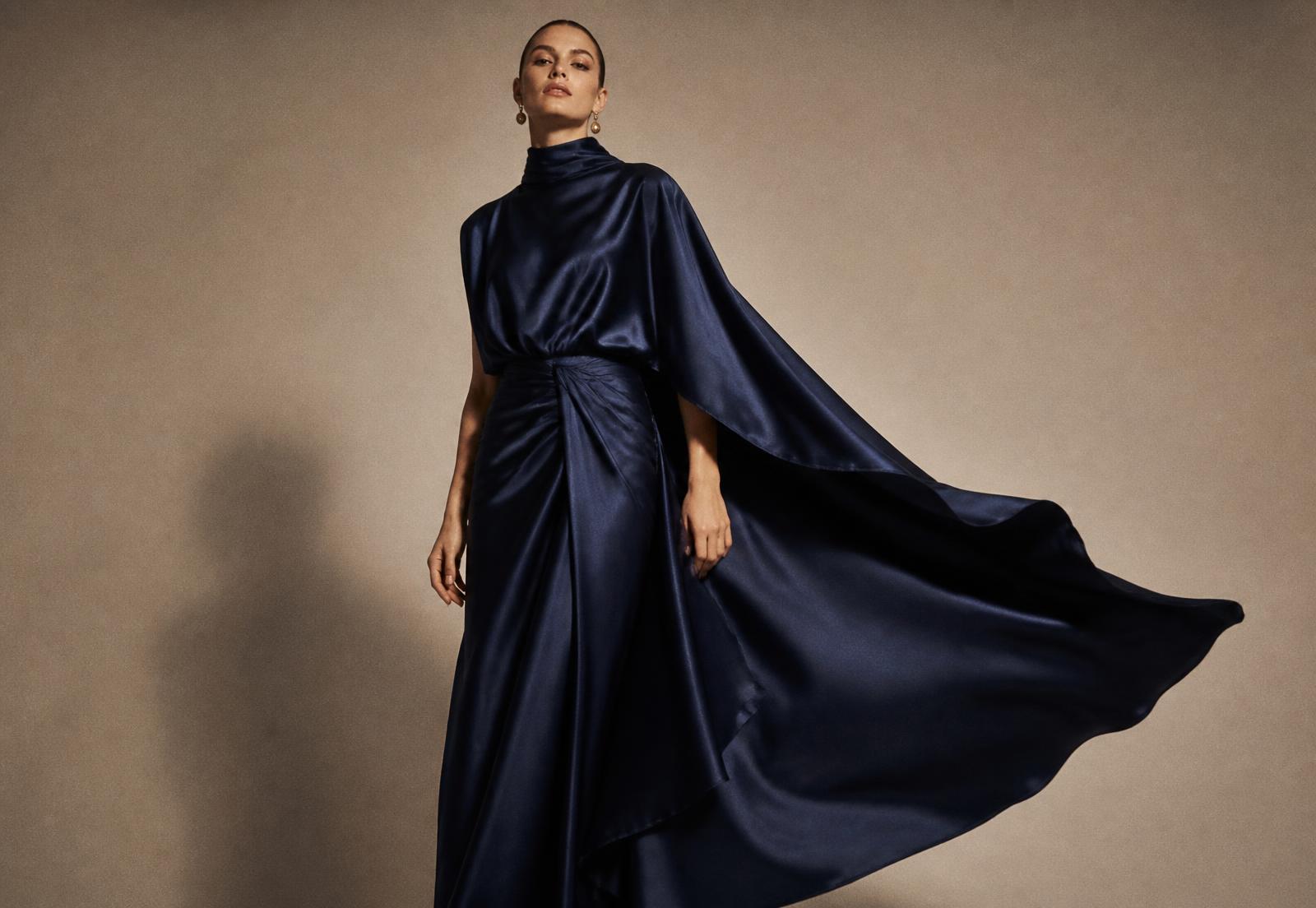 Di Rani model in a navy satin gown from The Other Side Collection